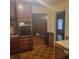 Well-lit kitchen with tile floors and oak cabinets, complemented by stainless appliances and a connected dining area at 9278 Seminole Rd, Jonesboro, GA 30236