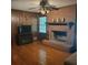 A cozy living room with a fireplace and wooden paneling creates a warm and inviting space at 9278 Seminole Rd, Jonesboro, GA 30236