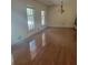 Living room featuring gleaming hardwood floors and natural light from large windows at 9278 Seminole Rd, Jonesboro, GA 30236
