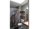 Modern bathroom with a stylish shower curtain and floating shelves at 1425 Watercrest Cir, Lawrenceville, GA 30043