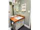 Bathroom vanity with wood countertop and white sink at 1425 Watercrest Cir, Lawrenceville, GA 30043