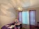Bedroom with chandelier-style lighting and purple accents at 1425 Watercrest Cir, Lawrenceville, GA 30043