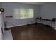 Spacious living room featuring wood floors, a brick fireplace, and bright window with natural light at 1425 Watercrest Cir, Lawrenceville, GA 30043