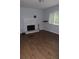 Living room featuring wood floors, a brick fireplace, and a large window with natural light at 1425 Watercrest Cir, Lawrenceville, GA 30043
