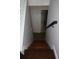 Staircase leading down with hardwood steps and white walls, and doors for access to rooms at 1425 Watercrest Cir, Lawrenceville, GA 30043