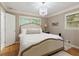 Cozy bedroom features natural light, neutral tones, and a decorative chandelier at 220 N Springs Ct, Sandy Springs, GA 30328
