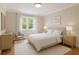 Neutral-toned bedroom with a comfortable bed, natural light, and contemporary decor at 220 N Springs Ct, Sandy Springs, GA 30328