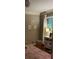Charming bedroom with a plush rug, artwork, and a window letting in natural light at 220 N Springs Ct, Sandy Springs, GA 30328