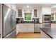 Well-equipped kitchen with stainless appliances, black counters, and hardwood floors at 220 N Springs Ct, Sandy Springs, GA 30328