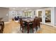 Inviting living area with hardwood floors, a dining table and access to a screened-in porch at 220 N Springs Ct, Sandy Springs, GA 30328