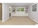 Bright living room features built-in cabinets, shelving, and large windows overlooking the backyard at 220 N Springs Ct, Sandy Springs, GA 30328