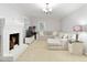Relaxing living room with a brick fireplace, plush seating, and a neutral color palette at 220 N Springs Ct, Sandy Springs, GA 30328