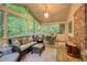 Relaxing screened porch featuring wood flooring and comfortable seating area surrounded by lush trees at 220 N Springs Ct, Sandy Springs, GA 30328