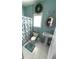 Bright bathroom with a pedestal sink, toilet, and a shower with a patterned curtain at 2532 Greenes Ln, Powder Springs, GA 30127