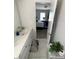 Bathroom with white vanity, leading into a bedroom with a neatly made bed and natural light at 2532 Greenes Ln, Powder Springs, GA 30127