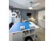 Well-lit craft room featuring a large work table, organized storage, and sewing equipment, perfect for hobbies at 2532 Greenes Ln, Powder Springs, GA 30127