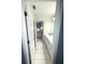 Hallway leading to a bathroom with a long vanity and tile floors, creating a clean and functional space at 2532 Greenes Ln, Powder Springs, GA 30127