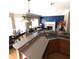 Open kitchen with an island, wood cabinets, and a view into the living area with fireplace at 2532 Greenes Ln, Powder Springs, GA 30127