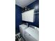 Neat laundry room featuring a washer, dryer, and upper cabinets for storage, set against navy blue walls at 2532 Greenes Ln, Powder Springs, GA 30127