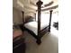 Main bedroom with a regal four-poster bed, providing a luxurious and comfortable space at 2532 Greenes Ln, Powder Springs, GA 30127