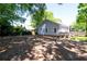 View of home's backyard, accented by a wooden deck and lush surrounding greenery at 3273 Elm St, Atlanta, GA 30337