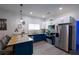 Modern kitchen with blue cabinets, stainless steel appliances, and an island with seating at 3273 Elm St, Atlanta, GA 30337