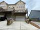 Townhouse with a spacious rear deck, parking, and garage for convenience at 790 Village Field Ct, Suwanee, GA 30024