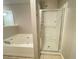 Bathroom features separate jacuzzi tub and shower with tile floor at 790 Village Field Ct, Suwanee, GA 30024