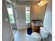 Bathroom with a window, wood vanity, sink, tiled floors, and a toilet at 790 Village Field Ct, Suwanee, GA 30024