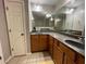 Bathroom with dual vanities, large mirror, and neutral paint at 790 Village Field Ct, Suwanee, GA 30024