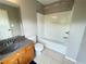 Bathroom with a vanity, sink, tiled floors, toilet, and tub with shower at 790 Village Field Ct, Suwanee, GA 30024