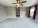 Bedroom showing carpet flooring, lots of natural light, and a ceiling fan at 790 Village Field Ct, Suwanee, GA 30024