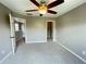 Spacious bedroom featuring neutral walls, carpeted floors, and a lighted ceiling fan at 790 Village Field Ct, Suwanee, GA 30024