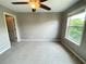 Bedroom with neutral walls, carpeted floors, and natural light from a large window at 790 Village Field Ct, Suwanee, GA 30024