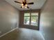 Cozy bedroom with carpet, ceiling fan, and natural light from the window at 790 Village Field Ct, Suwanee, GA 30024