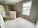 Upstairs landing or bonus room with a window, neutral paint, and carpeted flooring at 790 Village Field Ct, Suwanee, GA 30024