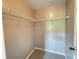 Walk-in closet with neutral walls, carpeted floor, and white rack and shelving storage system at 790 Village Field Ct, Suwanee, GA 30024