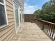 Exterior deck featuring a weathered wood floor and privacy fence with a view of foliage at 790 Village Field Ct, Suwanee, GA 30024