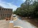 Exterior view from wood deck featuring green trees, landscaping, and parked car at 790 Village Field Ct, Suwanee, GA 30024
