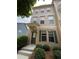Charming townhouse featuring a welcoming entrance and well-maintained landscaping at 790 Village Field Ct, Suwanee, GA 30024