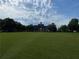 Community gazebo on expansive green space with tree line at 790 Village Field Ct, Suwanee, GA 30024