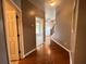 Hallway with hardwood floors leading to carpeted bedrooms and neutral paint at 790 Village Field Ct, Suwanee, GA 30024
