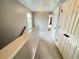 Upstairs hallway featuring neutral paint, plush carpet, window and doors with black hardware at 790 Village Field Ct, Suwanee, GA 30024