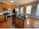 Kitchen with stainless steel appliances, a center island, and natural light from the windows at 790 Village Field Ct, Suwanee, GA 30024