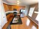 Kitchen with stainless steel appliances, island with sink, and natural lighting from nearby windows at 790 Village Field Ct, Suwanee, GA 30024
