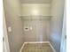 Empty laundry room space featuring tile floor, connections, and wire shelving at 790 Village Field Ct, Suwanee, GA 30024