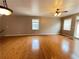 Spacious living room featuring hardwood floors, a cozy fireplace, and great natural light at 790 Village Field Ct, Suwanee, GA 30024