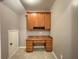 A home office offers a built-in desk and cabinets for organized storage and workspace at 790 Village Field Ct, Suwanee, GA 30024