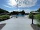 Beautiful community pool with lounge chairs and umbrellas on a sunny day at 790 Village Field Ct, Suwanee, GA 30024