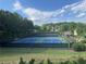 Well maintained community tennis courts with lights, set among lush green landscape at 790 Village Field Ct, Suwanee, GA 30024